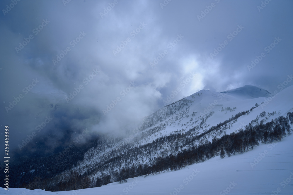 Obraz premium Image of a mountain covered with a snow cloud.