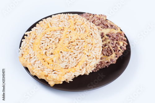 NangLet is a name of rice cake round and flat sweetmeat is a dessert in Thailand, Put on brown plate on white background isolated. photo