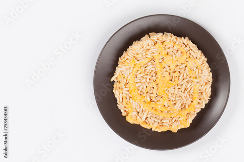 NangLet is a name of rice cake round and flat sweetmeat is a dessert in Thailand, Put on brown plate on white background isolated. photo