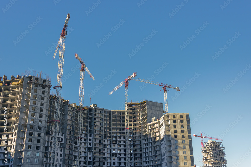 Large-scale construction of a residential complex with a view of construction cranes Large-scale construction of a residential complex with a view of construction cranes