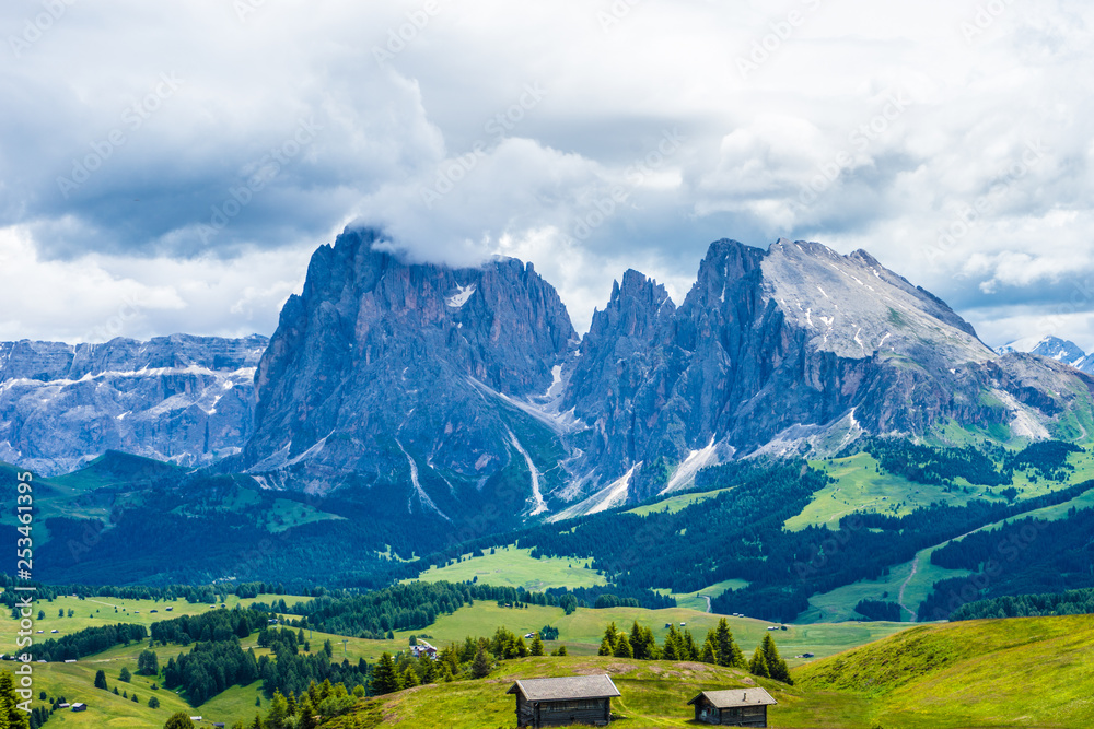 Alpe di Siusi, Seiser Alm with Sassolungo Langkofel Dolomite, a view of a large mountain in the background Alpe di Siusi, Seiser Alm with Sassolungo Langkofel Dolomite, a view of a large mountain in the background