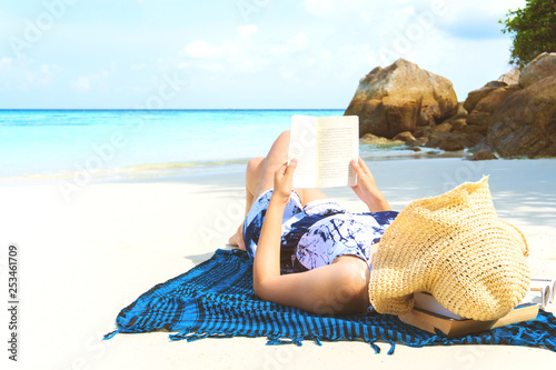 Summer Beach Holiday Woman reading a book on the beach in free time . #253461709