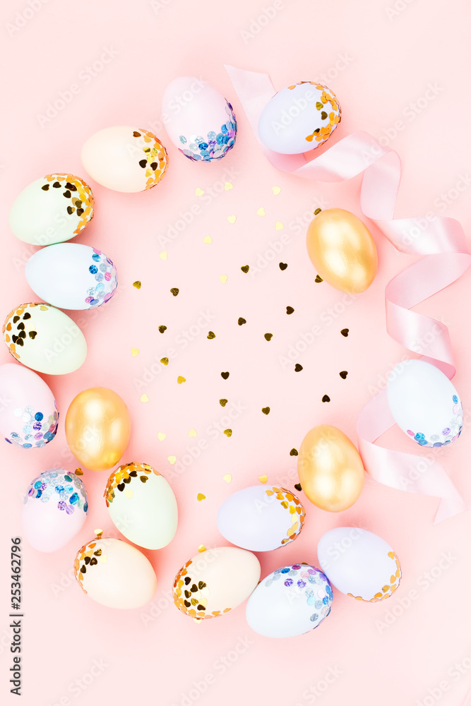 Festive Happy Easter background with decorated eggs, flowers, candy and ribbons in pastel colors on pink. Copy space Festive Happy Easter background with decorated eggs, flowers, candy and ribbons in pastel colors on pink. Copy space