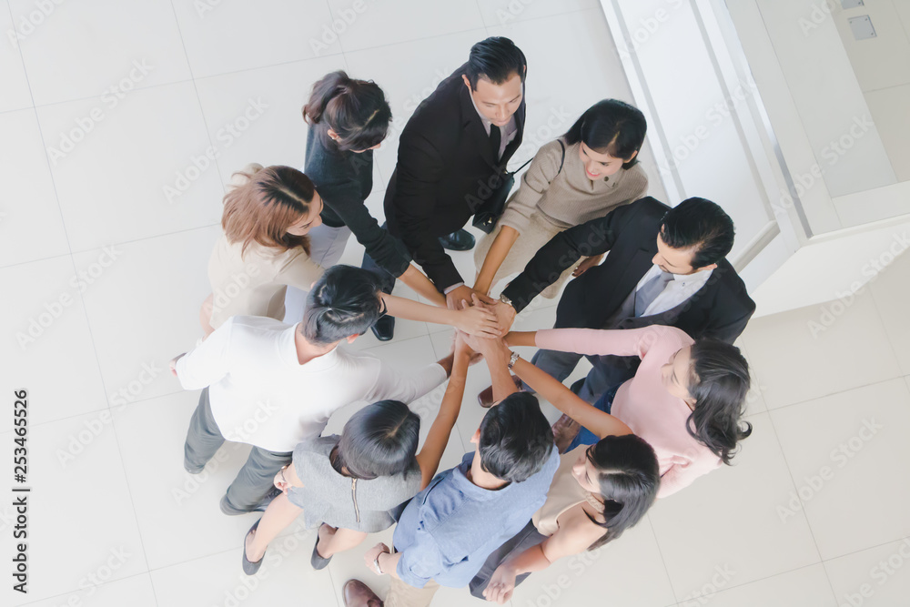Male and female businessmen join hands in the hall of office.Top view. Male and female businessmen join hands in the hall of office.Top view.