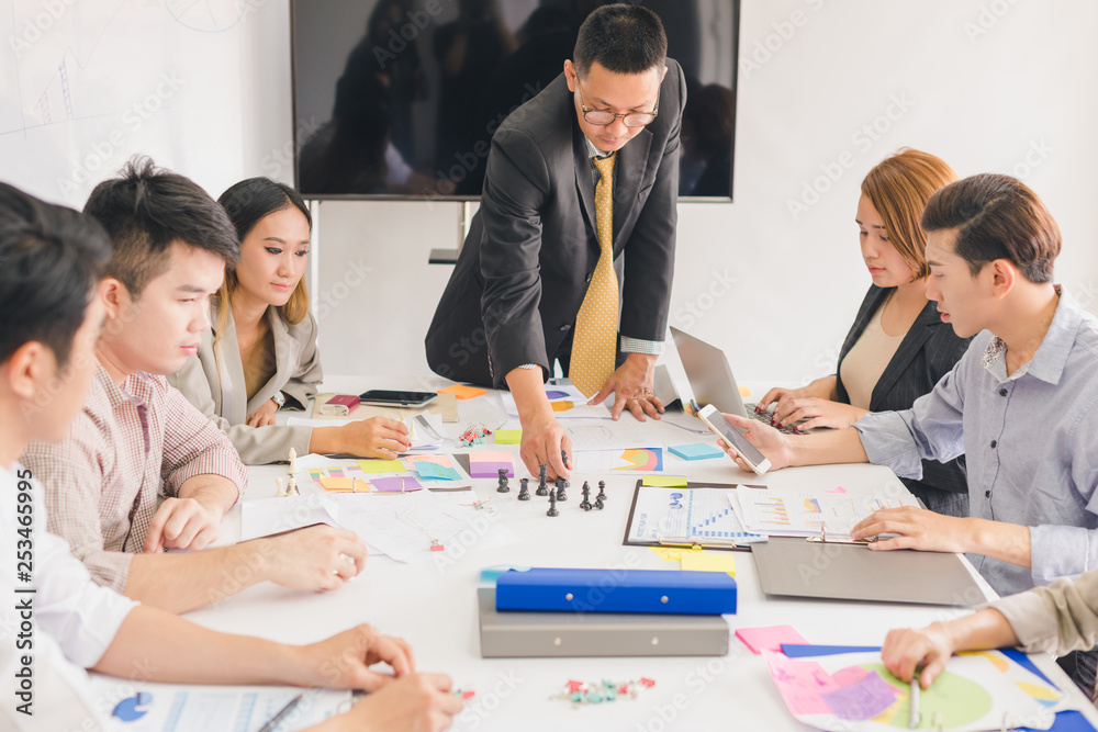 A group of Asian businessmen are discussing their work.All people share brainstorm ideas at work. A group of Asian businessmen are discussing their work.All people share brainstorm ideas at work.