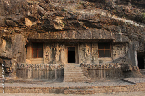 Outside view of Cave 2, doorway is flanked by huge Bodhisattvas with converging dwarfs above, Buddhist Caves, Ellora, Aurangabad, Maharashtra.