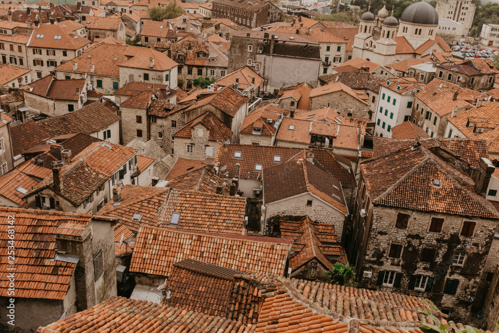 Panoramic aerial view of the red tiled roofs of the old town of Kotor. Panoramic aerial view of the red tiled roofs of the old town of Kotor.