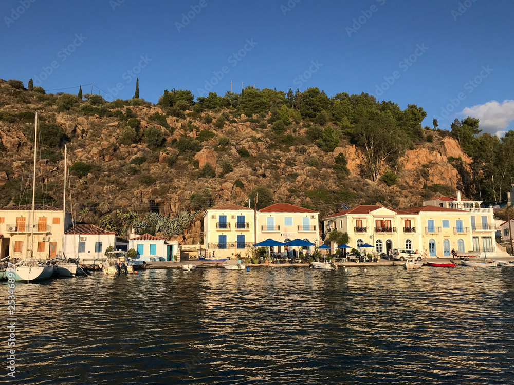 view from the yacht to the island with the traditional architecture in the Greek style