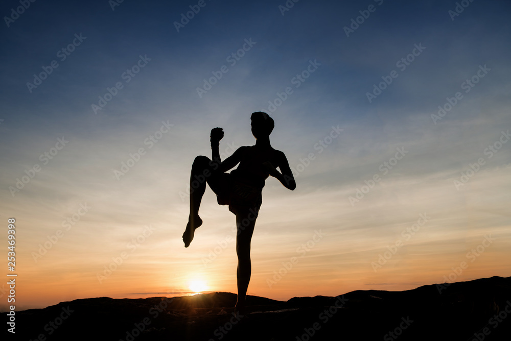 silhouette of a couple running on beach at sunset