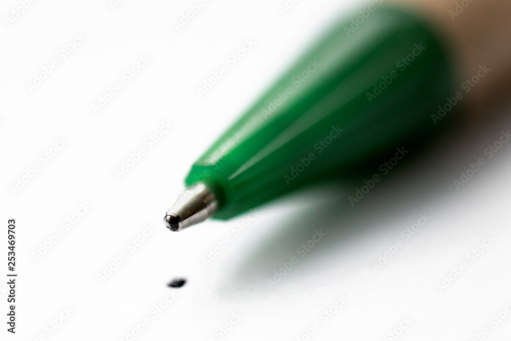 Ball pen tip and a dot on a white paper page sheet close up background. Ball pen tip and a dot on a white paper page sheet close up background.