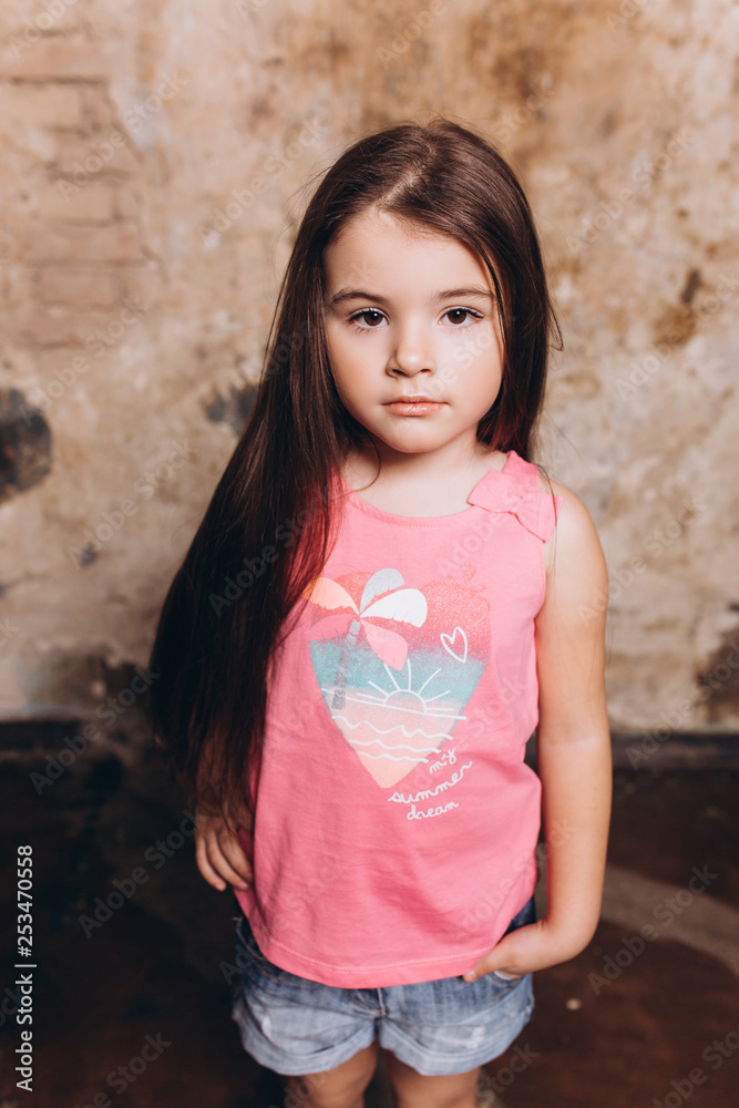 Close up fashion portrait of little cute baby girl posing in studio. Cheerful, fashion girl Close up fashion portrait of little cute baby girl posing in studio. Cheerful, fashion girl