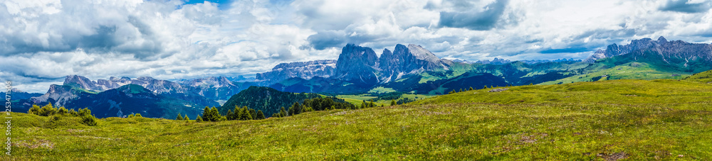 Alpe di Siusi, Seiser Alm with Sassolungo Langkofel Dolomite, a large green field with a mountain in the background panorama
