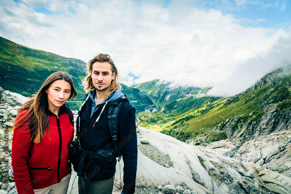 Young Couple Hiking In The Swiss Alps