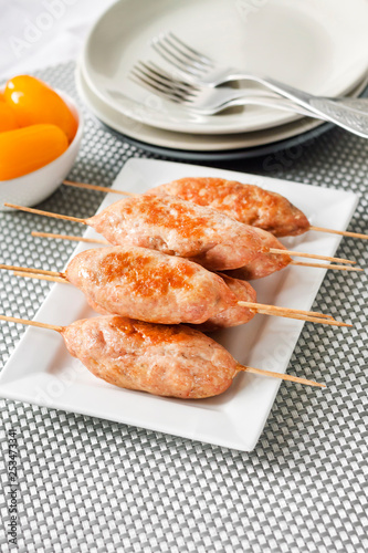 Minced turkey kebabs on square white plate