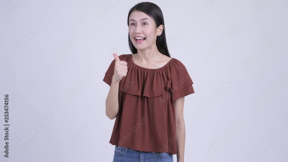 Happy beautiful Asian woman giving thumbs up Happy beautiful Asian woman giving thumbs up
