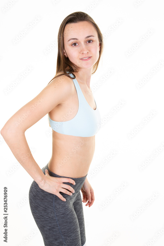Young beautiful woman in sportswear doing stretching isolated over white background Young beautiful woman in sportswear doing stretching isolated over white background