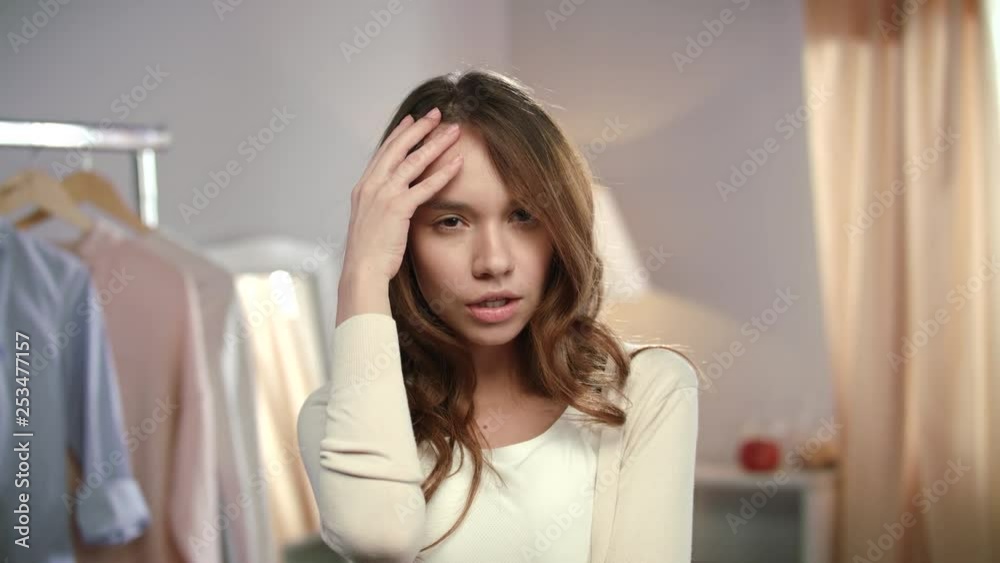 Portrait of young woman in home wardrobe. Young woman joking in front of mirror Portrait of young woman in home wardrobe. Young woman joking in front of mirror