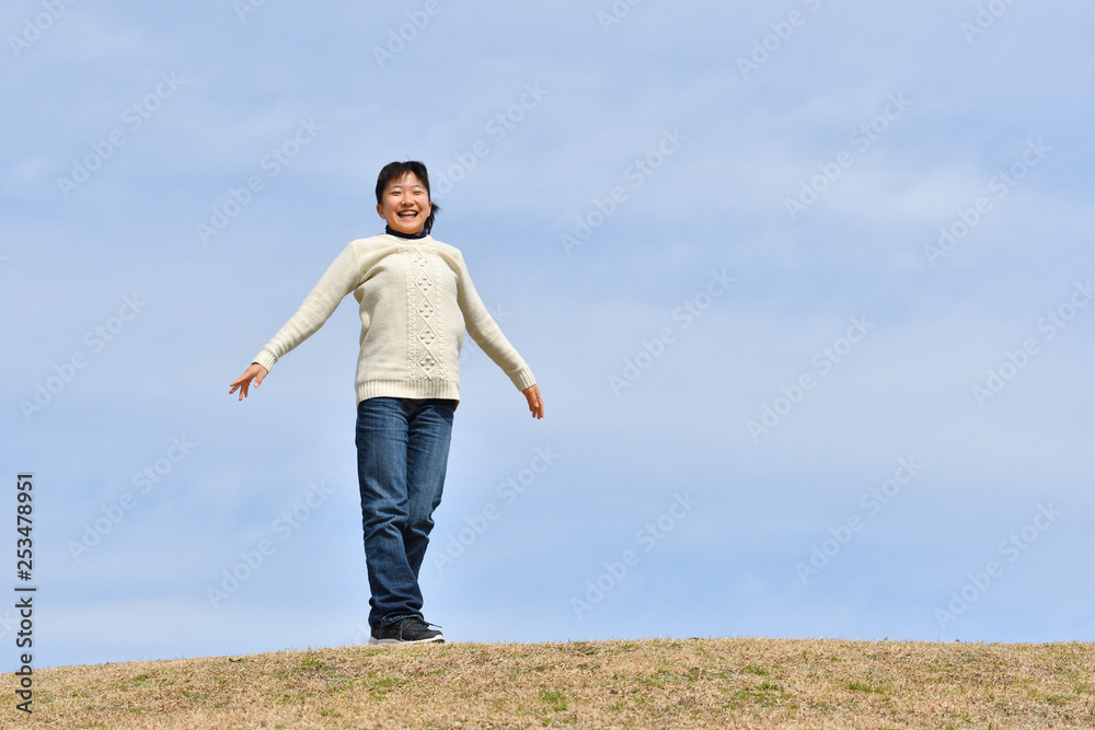 Japanese girl smiling in the blue sky Japanese girl smiling in the blue sky