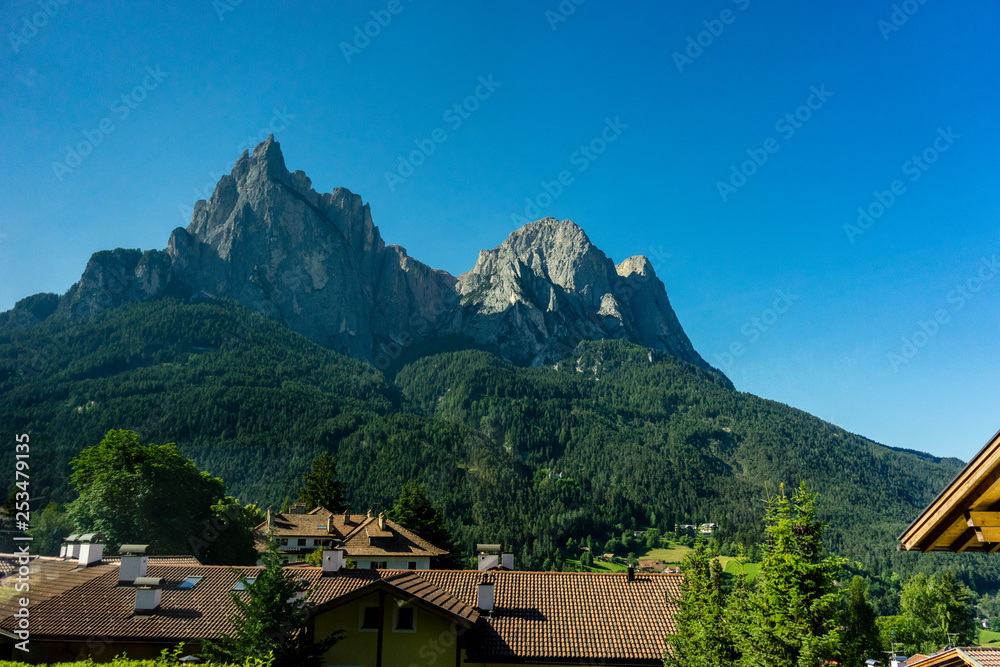 Italy, train from Bolzano to Venice, a building with a mountain in the background