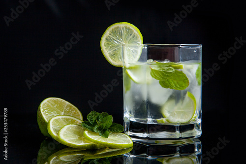 Summer cocktail mojito in glass on black background..