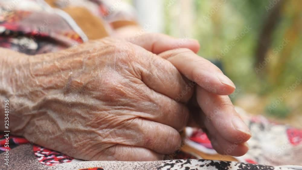 Wrinkled arms of senior woman outside. Grandmother stroking her hands outdoor. Close up Side view Slow motion Wrinkled arms of senior woman outside. Grandmother stroking her hands outdoor. Close up Side view Slow motion