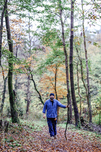 Hiker - man hiking in forest