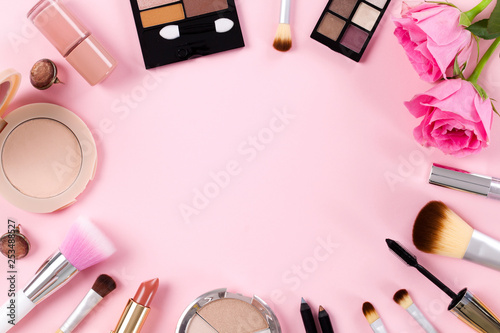 Makeup products on a pink background