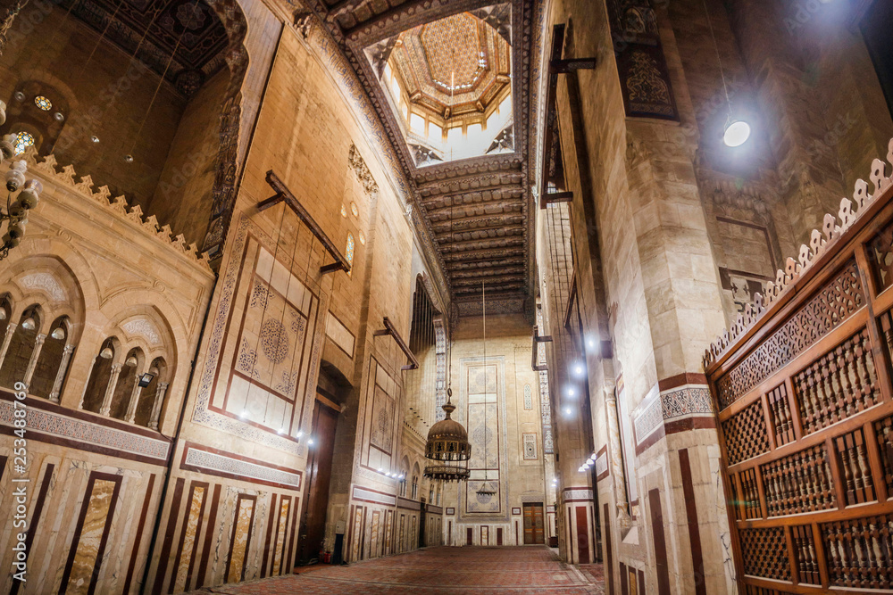 CAIRO, EGYPT  Interior of Al-Refai Mosque with old decorated stone walls of bricks, colored marble decoration, wooden decorative ceiling, large brass chandeliers and wooden lattice doors, Cairo, Egypt
