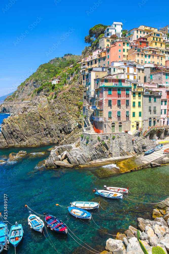Boats on the sea with the historic architecture of Cinque Terre