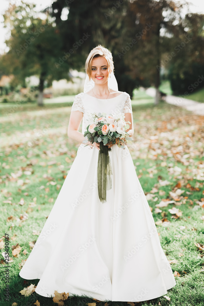 Bride holding big and beautiful wedding bouquet with flowers