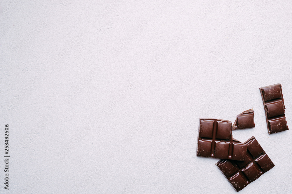 broken chocolate bar on white backdrop. confectionery design. sweets background broken chocolate bar on white backdrop. confectionery design. sweets background