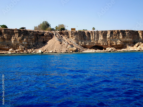 Blue sea and rocky shore. The rocky coast of the red sea, Sharm El Sheikh.