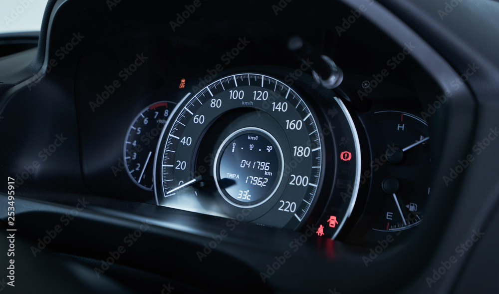 Close up of modern speedometer display in a car dashboard panel .