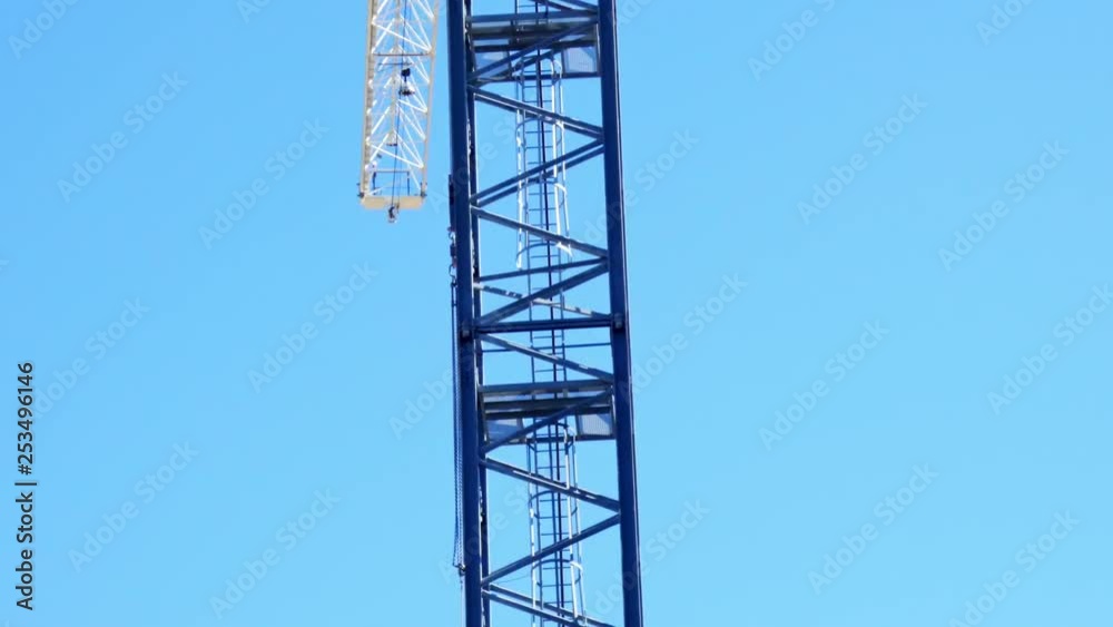 camera panning down a cranes structure with blue sky in background camera panning down a cranes structure with blue sky in background