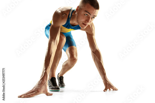 Young caucasian man preparing to run isolated on white studio background. One male runner or jogger. Silhouette of jogging athlete with shadows. © master1305