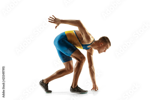 Young caucasian man preparing to run isolated on white studio background. One male runner or jogger. Silhouette of jogging athlete with shadows.