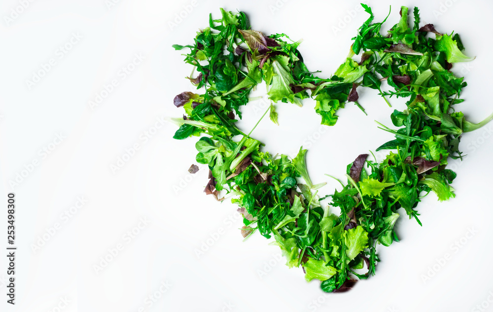Mixed salad leaf. Lettuce spinach isolated on white background, heart shape from greenery