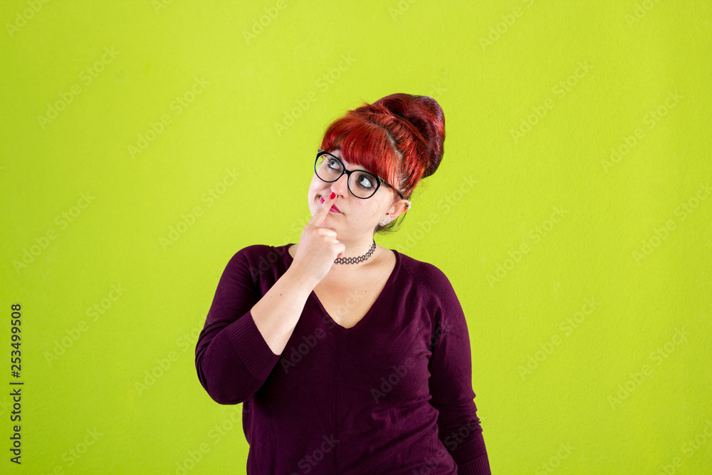 Let me think. Doubtful pensive woman with thoughtful expression, presses lips together, keeps hand under chin, plans something or makes choice Let me think. Doubtful pensive woman with thoughtful expression, presses lips together, keeps hand under chin, plans something or makes choice