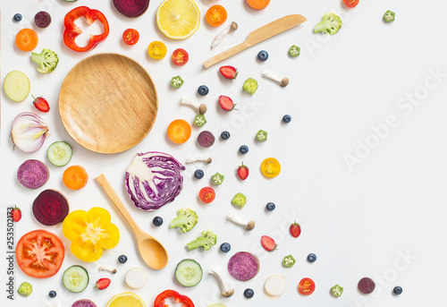 Flat lay colourful assorted vegan food slice on white background. Empty plate text space image.