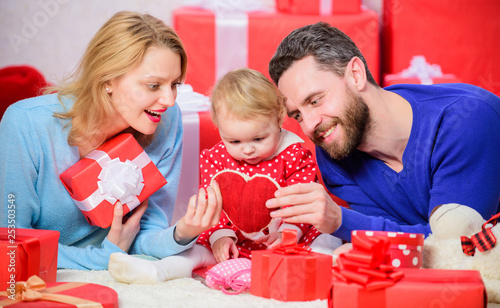 Shopping online. Happy loving couple. Happy family with present box. Love and trust in family. Bearded man and woman with little girl. Valentines day. Red boxes. father, mother and doughter child
