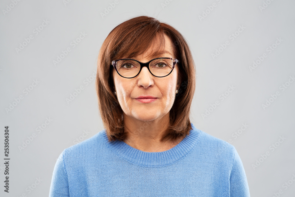 vision and old people concept - portrait of senior woman in glasses over grey background