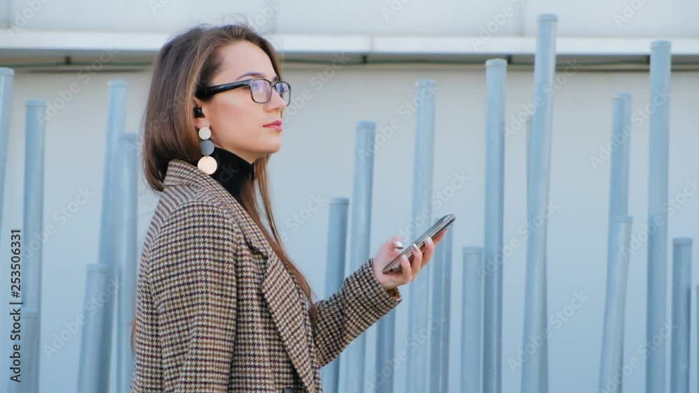 Slow motion of young business woman with mobile phone Slow motion of young business woman with mobile phone