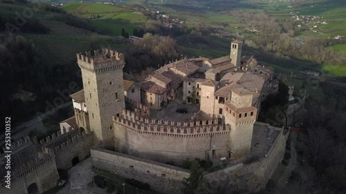 Drone aerial video in an orbit track of the entire ancien small village with the tower of Vigoleno in the Piacenza province in Italy. photo