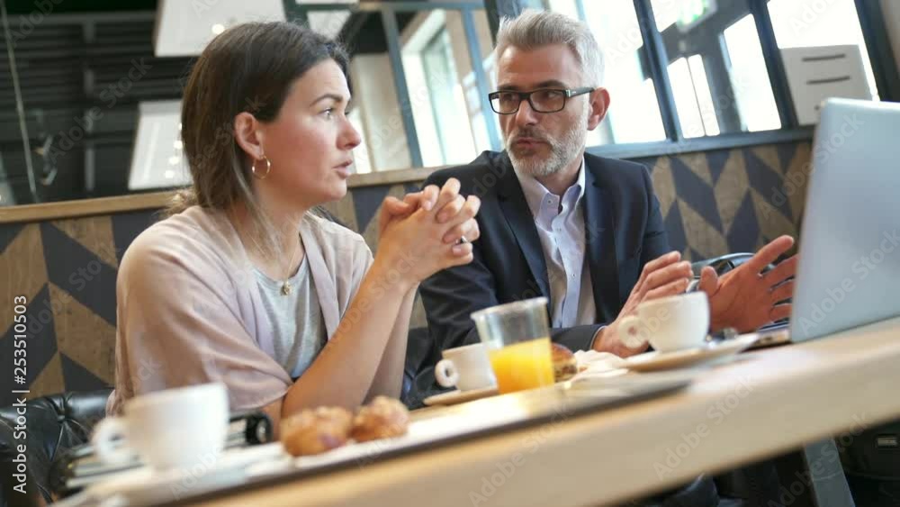Salesman and manager talking during informal breakfast meeting Salesman and manager talking during informal breakfast meeting