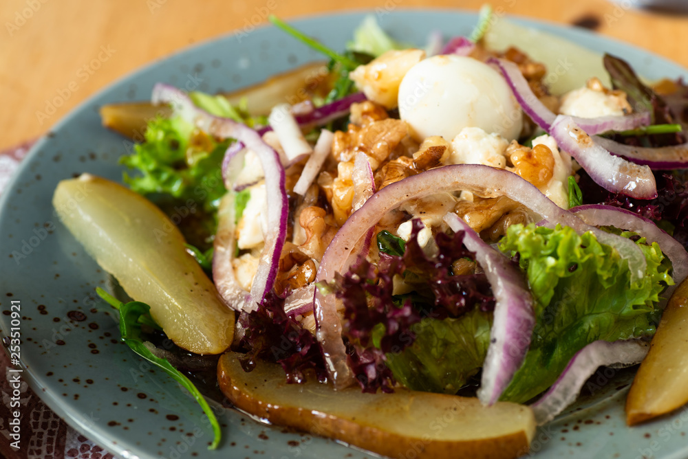 Vegetable salad with pear, walnut, onion circle, quail egg and lettuce. Vegetable salad with pear, walnut, onion circle, quail egg and lettuce.