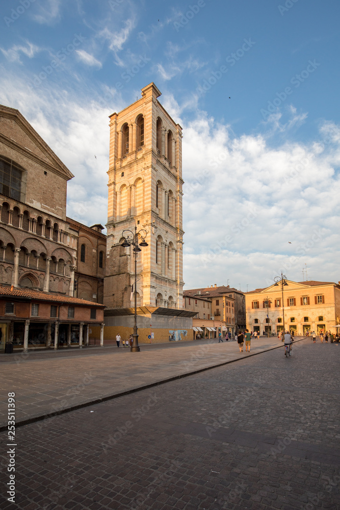 Ferrara, Italy - June 10, 2017: Scene of the Piazza Trento e Trieste and the cathedral tower, with local and tourists, in Ferrara, Emilia-Romagna, Italy