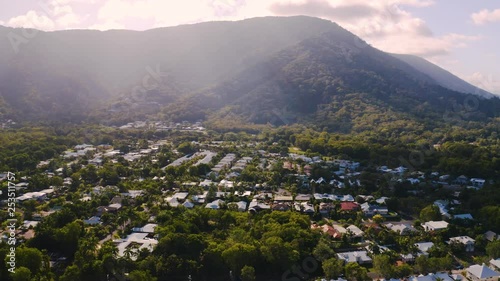 Aerial view on Palm Cove suburbean town situated in the middle of  forest  at the foot of the mountain with tropical vegetation in Queensland, Australia