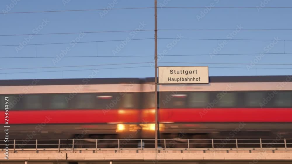 stuttgart railway billboard train passing behind train station signboard
