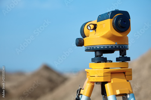 Special device (level) for surveyor builders, geodesy equipment close up. Outdoors, copy space. photo