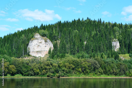 Rocky coast with forest on the river